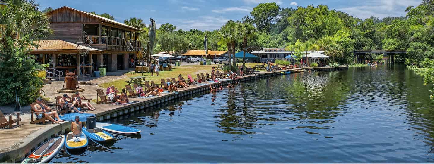 landscape picture of Wekiva Island with people hanging out next to the water